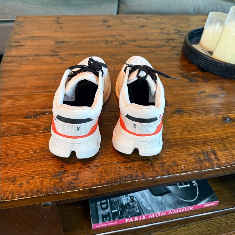 On Running White and Black Athletic Shoes with Red Accents